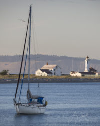 Fort Worden Wilson Lighthouse at Sunset with boat