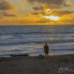 Man and Sunrise over Kailua Beach and the Mokuluas